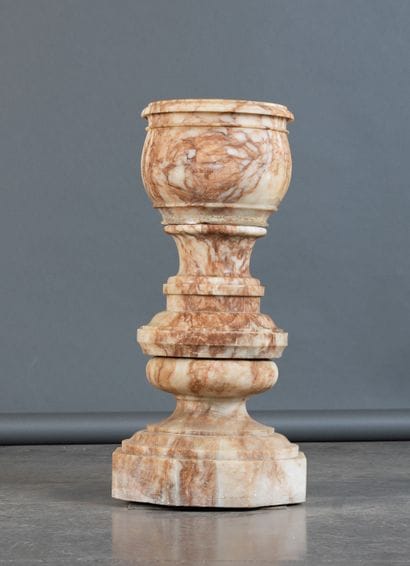 Bowl resting on a turned, molded base made...