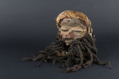 A human-faced dance mask featuring a slightly...