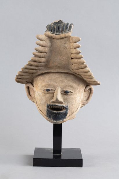 Head of a figure. The mouth is open, revealing...