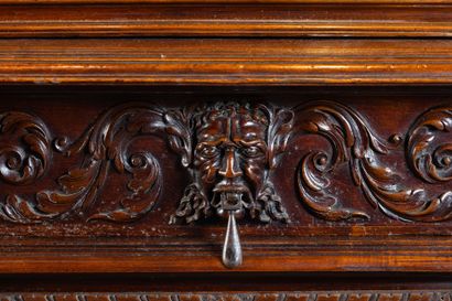 Two-part cabinet in molded and carved walnut,...