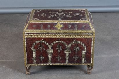 Leather-covered chest with a studded design...