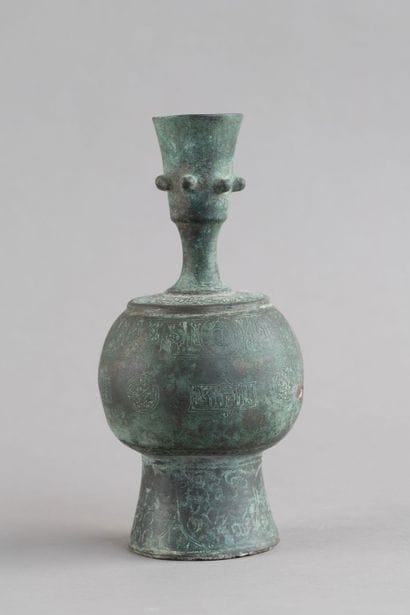 Bronze bottle with a rounded body, resting...