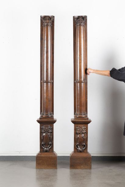 Pair of walnut half-columns with carved capitals...