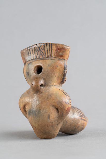 Female statuette depicted in a crouching...