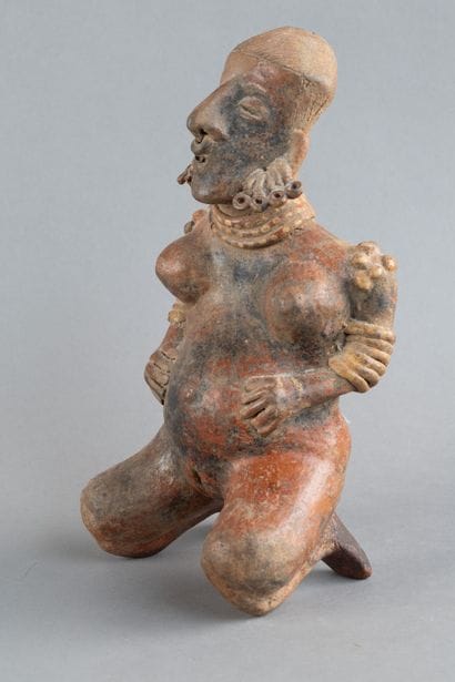 Statuette of a woman in labor. She is depicted...