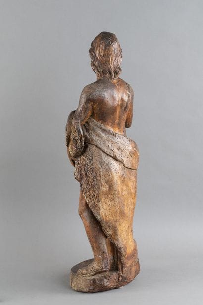 A carved wooden statue of Saint John the...