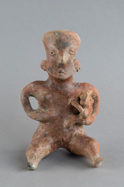 A mother is depicted seated, holding her...