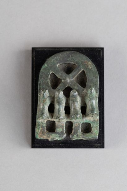 Belt buckle decorated with four mammals....