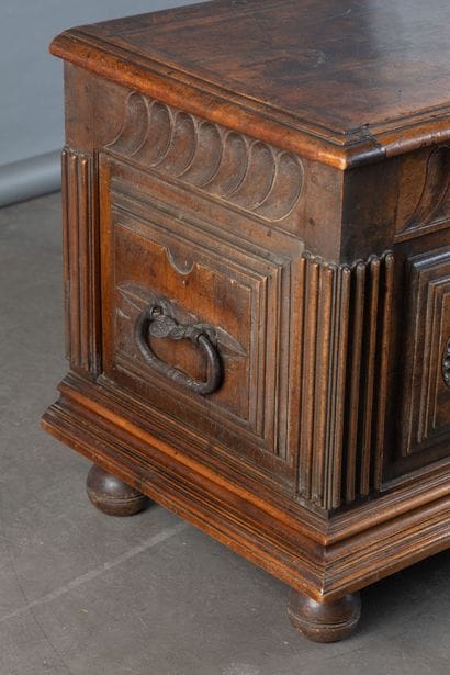 Walnut chest with a front panel featuring...