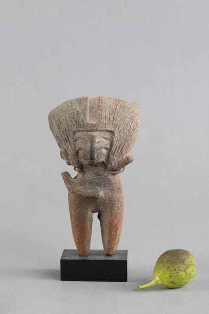 Female statuette. The hairstyle is notable,...