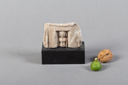 Upper part of a votive statuette depicting...