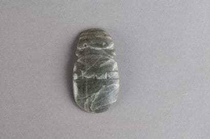 Anthropomorphic axe pendant. Veined green...