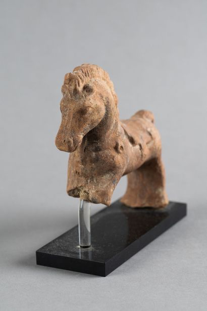 Statuette de cheval harnaché. Terre cuite....