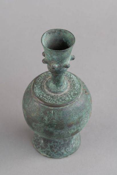 Bronze bottle with a rounded body, resting...