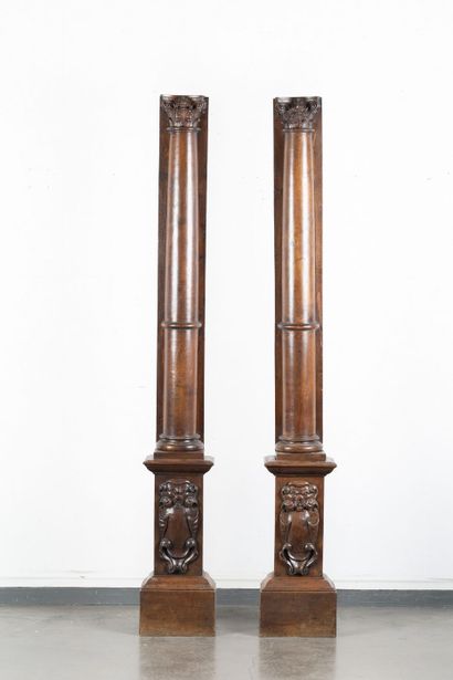 Pair of walnut half-columns with carved capitals...