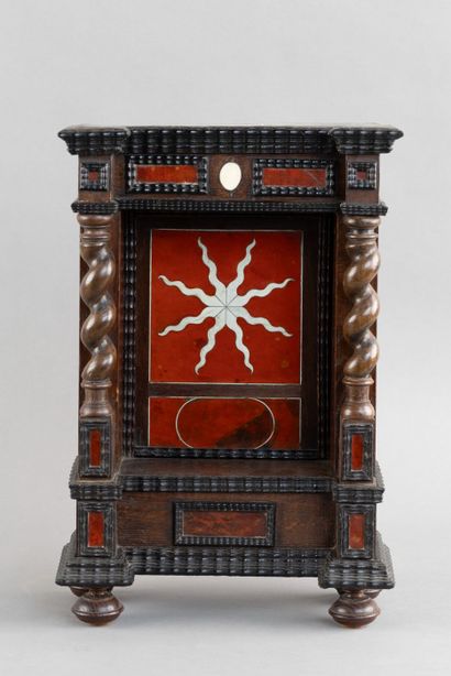 Display case with a niche framed by twisted...