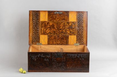 Cedar chest with a top-opening lid, featuring...