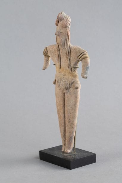 Statuette depicted standing with both short...