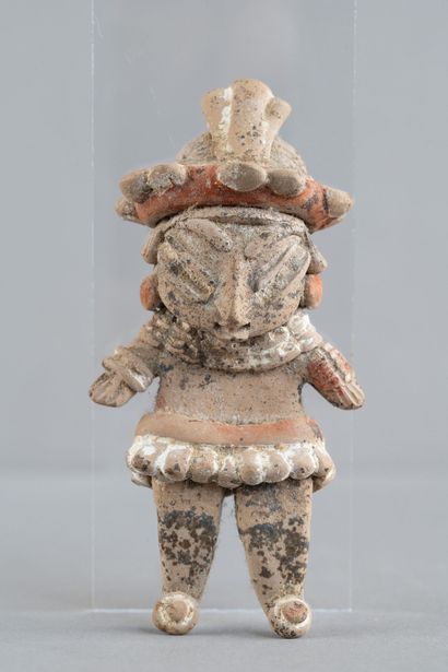 Statuette of a standing woman. She is adorned...