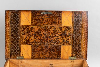 Cedar chest with a top-opening lid, featuring...
