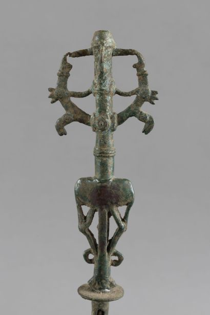 Flag finial depicting a hero subduing two...