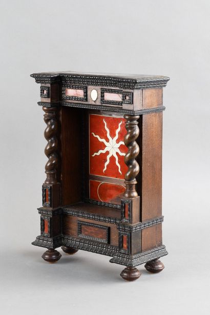Display case with a niche framed by twisted...