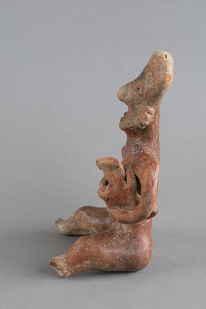 A mother is depicted seated, holding her...