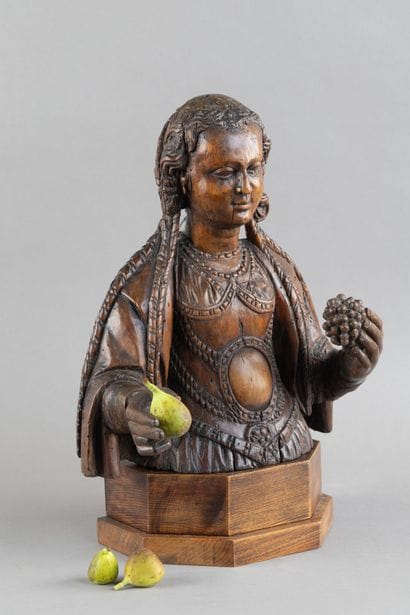 Carved wooden bust of a saintly woman. She...