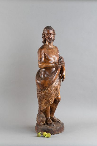 A carved wooden statue of Saint John the...