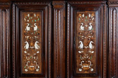 Two-part cabinet in molded and carved walnut,...