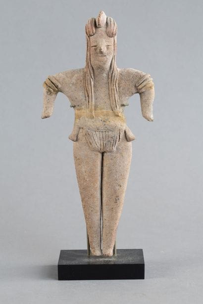 Statuette depicted standing with both short...