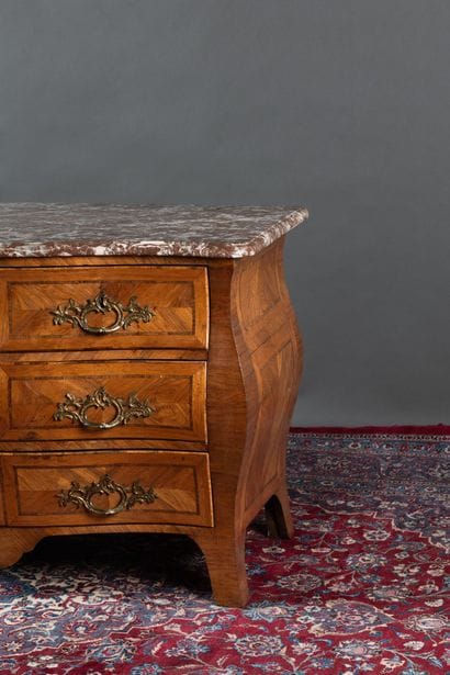 A curved chest of drawers with a rounded...
