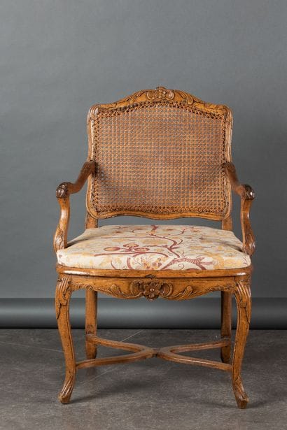 Molded and carved beech armchair, cane-woven...