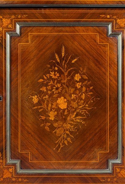 A counter-height cabinet made of veneered...