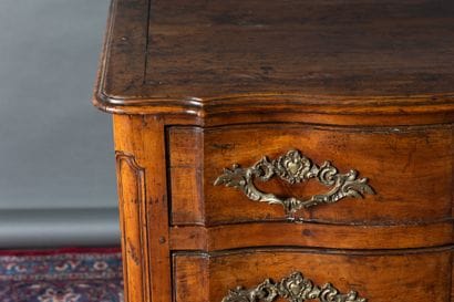 Molded cherry wood chest of drawers. Features...