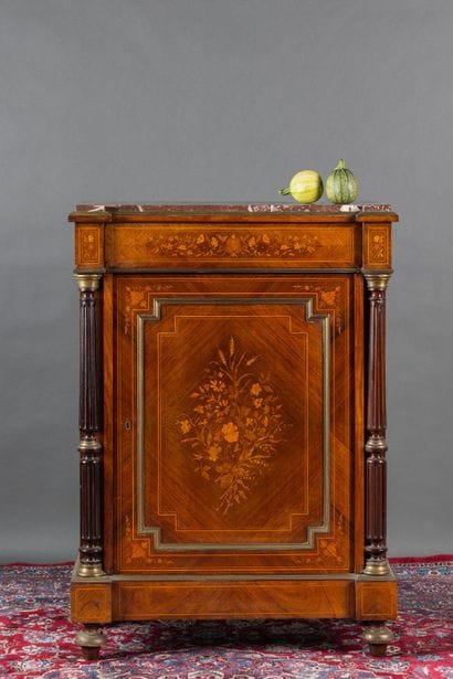 A counter-height cabinet made of veneered...