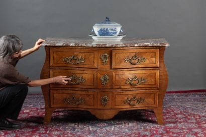 A curved chest of drawers with a rounded...