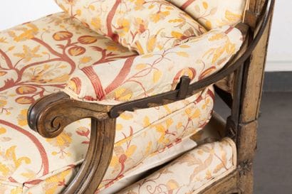 Molded and carved walnut armchair with rack-mounted...