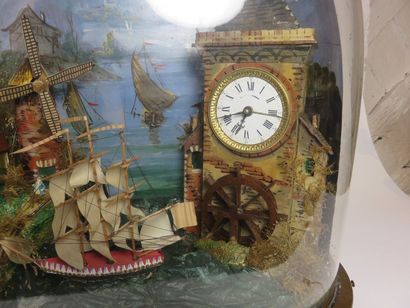 Pendule automate sous globe. A droite, un...