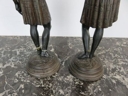 Deux bougeoirs en régule patiné et réhauts...