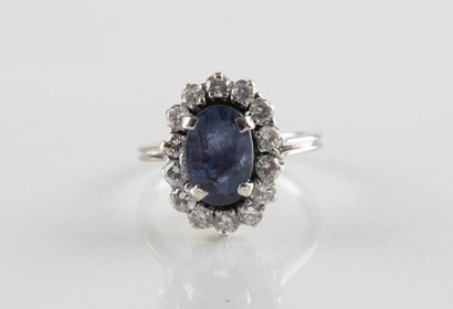 Bague en or gris ornée au centre d'un saphir...