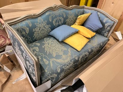 Sofa in cream relacquered wood, the sinuous...