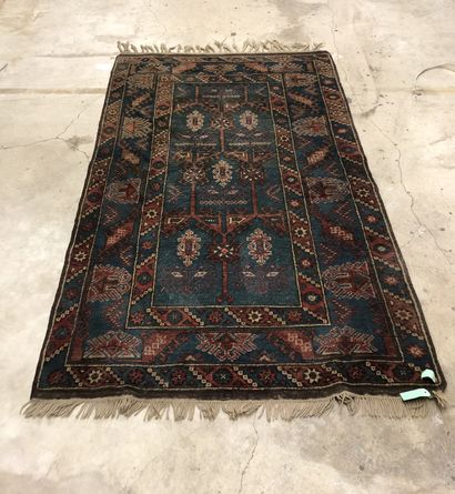 Wool carpet with geometric design on a blue...