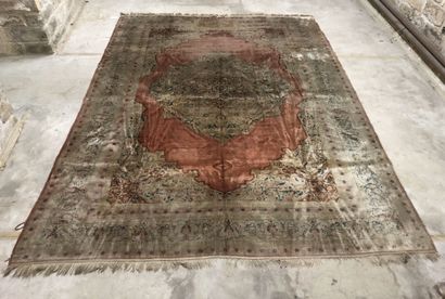 Wool and silk carpet decorated with a central...