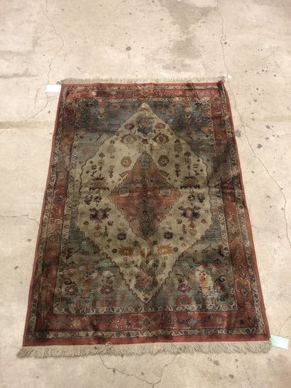 Wool and silk carpet decorated with a central...