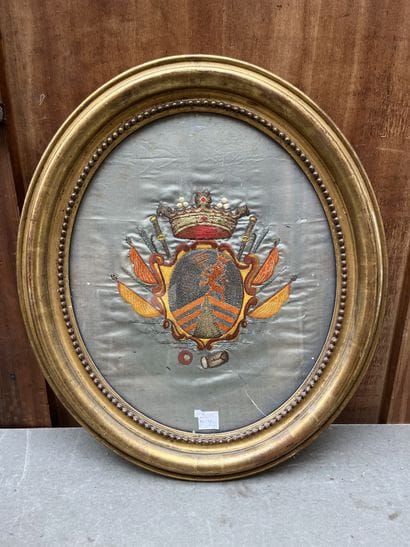 Embroidered coat of arms in a gilded wood...