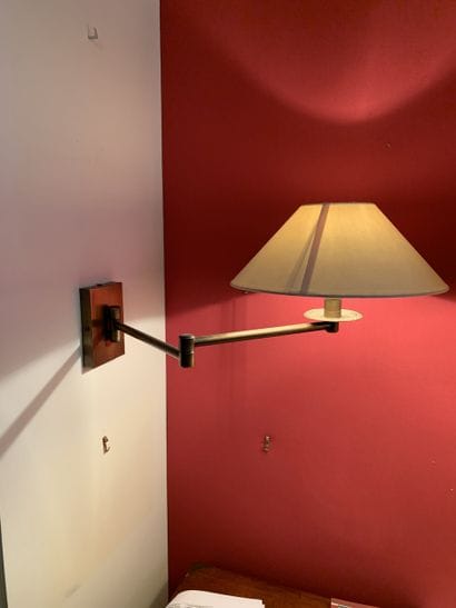 Thirteen gilded brass sconces and their shades....