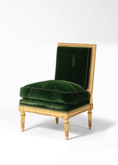 Chaise basse 
en bois redoré, à dossier rectangulaire...