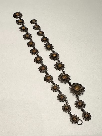 Collier 
en fils d'argent dessinant une course...