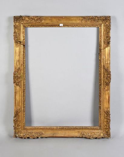 Carved and gilded wooden frame with scroll...